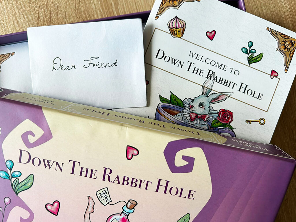 Die geöffnete Box und etwas Spielmaterial von Down the Rabbit Hole.