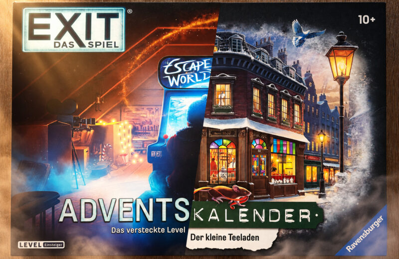 Ein Adventskalender liegt auf einem Tisch. eine Hälfte ist der Kalender „Das versteckte Level“, die andere Hälfte „Der kleine Teeladen“.