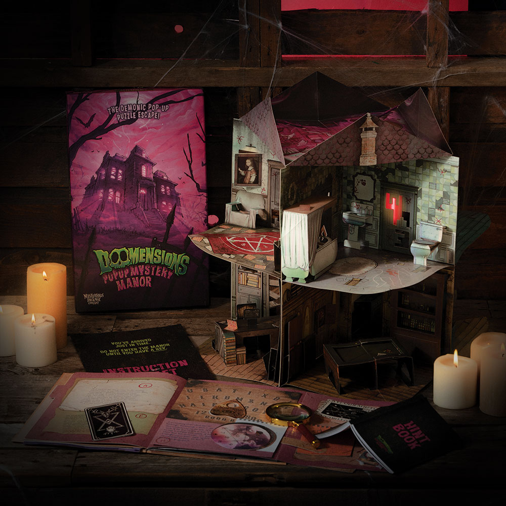 The box for “Doomensions: Mystery Manor” stands next to the game itself on a table.